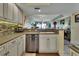 Bright kitchen with stainless steel appliances and a view of the open concept living area and water at 4670 Links Village Dr # B706, Ponce Inlet, FL 32127