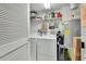 Functional laundry room with washer, dryer, shelving for storage, and a water heater at 4670 Links Village Dr # B706, Ponce Inlet, FL 32127