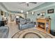 Cozy living room with a fireplace and leather recliners and open access to kitchen at 4670 Links Village Dr # B706, Ponce Inlet, FL 32127