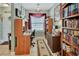 Well-organized office space featuring a desk, chair, bookshelves, and a large window with natural light at 4670 Links Village Dr # B706, Ponce Inlet, FL 32127