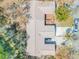 Birds-eye view of a home with a well-maintained roof and mature trees at 49 Crooked Pine Rd, Port Orange, FL 32128