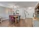 Dining room boasts wood floors, stylish light fixture, and views into the kitchen, perfect for entertaining at 49 Crooked Pine Rd, Port Orange, FL 32128