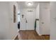 Bright entryway with wood-look flooring, coat rack, and white walls providing a fresh, clean aesthetic at 49 Crooked Pine Rd, Port Orange, FL 32128