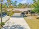 Charming single-story home featuring a two-car garage, stone accents, and a well-maintained front yard at 49 Crooked Pine Rd, Port Orange, FL 32128