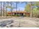 Front of clubhouse featuring an American flag in the center and ample parking at 49 Crooked Pine Rd, Port Orange, FL 32128