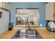 Well-lit kitchen with wood counters and a sink overlooking the living room at 49 Crooked Pine Rd, Port Orange, FL 32128