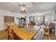 Bright and open living and dining area featuring wood floors, comfortable seating, and natural light at 49 Crooked Pine Rd, Port Orange, FL 32128