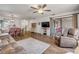 Open-concept living and dining area with access to screened in patio at 49 Crooked Pine Rd, Port Orange, FL 32128