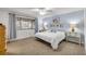 Bright main bedroom with light blue walls, carpet, and a scenic view at 49 Crooked Pine Rd, Port Orange, FL 32128