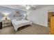 Main bedroom with carpet, light blue walls, and two matching nightstands at 49 Crooked Pine Rd, Port Orange, FL 32128