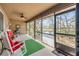 Sunroom with rocking chairs overlooking the water and foliage outside at 49 Crooked Pine Rd, Port Orange, FL 32128