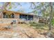 Back exterior shot, showcasing a screened-in porch and yard at 49 Crooked Pine Rd, Port Orange, FL 32128