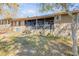 Rear exterior showcasing a screened porch and cozy backyard at 49 Crooked Pine Rd, Port Orange, FL 32128
