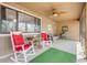 Relaxing screened porch featuring rocking chairs, ceiling fan, and a view of the backyard at 49 Crooked Pine Rd, Port Orange, FL 32128