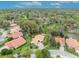 Lovely aerial view of home with a curved driveway, pristine landscaping, and mature trees at 509 Osprey Ln, Winter Springs, FL 32708