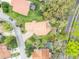 An aerial view shows the tile roof home with a brick driveway, mature trees, and a refreshing pool at 509 Osprey Ln, Winter Springs, FL 32708