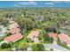 Lovely aerial view of home with a curved driveway, pristine landscaping, and mature trees at 509 Osprey Ln, Winter Springs, FL 32708