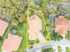 An aerial view shows the tile roof home with a brick driveway, mature trees, and a refreshing pool at 509 Osprey Ln, Winter Springs, FL 32708