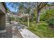 Relaxing outdoor space featuring a covered patio with string lights and lush landscaping at 509 Osprey Ln, Winter Springs, FL 32708