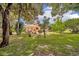 Expansive backyard features a patio, lush greenery, and mature trees, perfect for outdoor living and entertaining at 509 Osprey Ln, Winter Springs, FL 32708