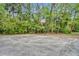 Outdoor concrete basketball court surrounded by trees and lush vegetation at 509 Osprey Ln, Winter Springs, FL 32708
