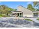 Exterior view of a modern clubhouse with an angled roof, landscaping, and parking at 509 Osprey Ln, Winter Springs, FL 32708