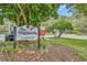 Sign for 'The Highlands' clubhouse, surrounded by lush greenery and well-maintained landscaping at 509 Osprey Ln, Winter Springs, FL 32708