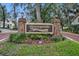 Greenspointe private community entrance with brick columns, beautiful landscaping, and a paved road at 509 Osprey Ln, Winter Springs, FL 32708