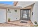 Inviting front entrance featuring a decorative butterfly accent, welcome mat and paved walkway at 509 Osprey Ln, Winter Springs, FL 32708