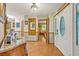 Bright foyer featuring hardwood floors, interior doors, and a front door with stained glass oval window at 509 Osprey Ln, Winter Springs, FL 32708