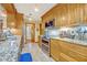 Modern kitchen featuring stainless steel appliances, granite countertops, and light wood cabinetry at 509 Osprey Ln, Winter Springs, FL 32708