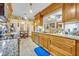 Kitchen featuring tile floors, wooden cabinets and granite countertops, plus an adjacent breakfast nook at 509 Osprey Ln, Winter Springs, FL 32708