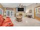 Warm living room with fireplace, red seating, and tiled flooring at 509 Osprey Ln, Winter Springs, FL 32708