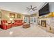 Cozy living room with a fireplace, plush red seating, and large tile flooring at 509 Osprey Ln, Winter Springs, FL 32708
