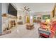 Spacious living room with a tile fireplace, ceiling fan, and view to the dining area at 509 Osprey Ln, Winter Springs, FL 32708