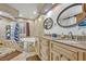 Bathroom featuring dual sinks, granite countertops, a soaking tub, and tiled shower with glass block at 509 Osprey Ln, Winter Springs, FL 32708