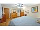 Bright main bedroom featuring hardwood floors, fan, and an ample dresser space at 509 Osprey Ln, Winter Springs, FL 32708