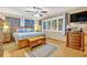 Serene main bedroom with hardwood floors, plantation shutters, and a ceiling fan at 509 Osprey Ln, Winter Springs, FL 32708