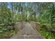 Scenic nature trail with a wooden bridge winding through a lush, wooded area at 509 Osprey Ln, Winter Springs, FL 32708