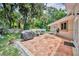 Outdoor patio featuring brick pavers, a grill, seating, and mature landscaping, perfect for entertaining at 509 Osprey Ln, Winter Springs, FL 32708