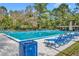 Community pool with lounge chairs and a covered pavilion, perfect for relaxation and recreation at 509 Osprey Ln, Winter Springs, FL 32708