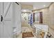 Bathroom featuring tiled shower with glass block, a soaking tub, and a sliding barn door at 509 Osprey Ln, Winter Springs, FL 32708