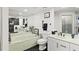 Elegant bathroom featuring dual sinks, a tub, and modern fixtures and decor at 521 Marina Point Dr # 521, Daytona Beach, FL 32114