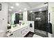 Modern bathroom featuring dual sinks, marble accents, and a sleek glass shower at 521 Marina Point Dr # 521, Daytona Beach, FL 32114