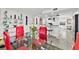 Bright dining room featuring a glass table with red chairs and contemporary decor at 521 Marina Point Dr # 521, Daytona Beach, FL 32114