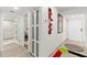 Bright hallway featuring modern art and access to a bathroom with a marble shower and a bedroom at 521 Marina Point Dr # 521, Daytona Beach, FL 32114