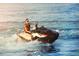 Personal enjoying a ride on a jet ski, highlighting the recreational activities available in the waterfront community at 521 Marina Point Dr # 521, Daytona Beach, FL 32114