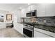 Stainless steel oven and microwave are set amongst white cabinets and granite countertops at 521 Marina Point Dr # 521, Daytona Beach, FL 32114