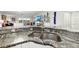 Close up of a kitchen sink set in a granite countertop with modern appliances at 521 Marina Point Dr # 521, Daytona Beach, FL 32114