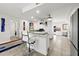 Bright kitchen with white cabinetry, breakfast bar, and view into office area at 521 Marina Point Dr # 521, Daytona Beach, FL 32114
